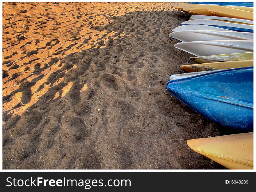 Canoes lying on the beach nearby the lake.