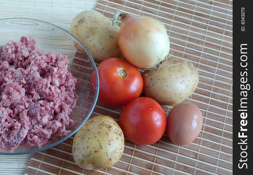 Raw ingredients. Meat stuffing, eggs and potato