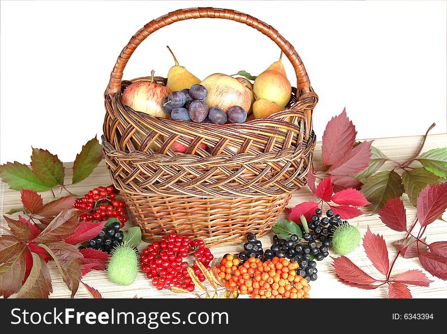 Autumn fruit and berries in a basket. Autumn fruit and berries in a basket