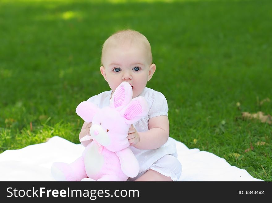 A baby shot of at a park outdoor with toy