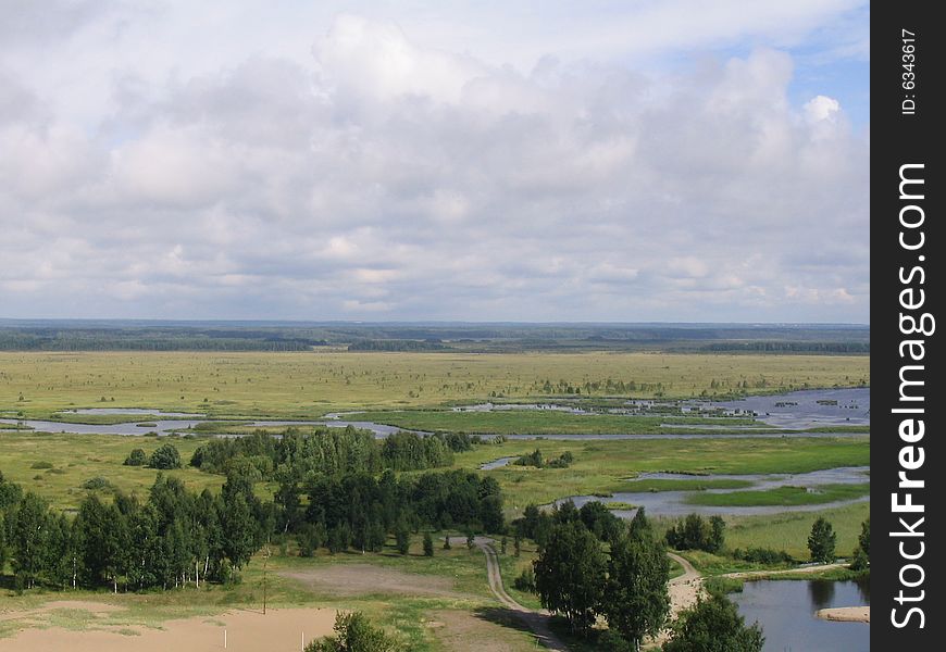 Endless field with trees, small lakes and send. Endless field with trees, small lakes and send.