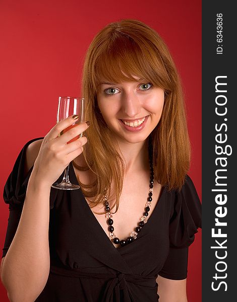 Beautiful girl with champagne glass isolated on red background