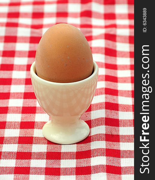 Shot of a boiled egg in eggcup on table