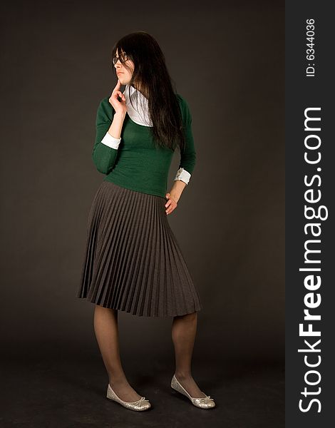 Young girl in business outfit isolated on black background