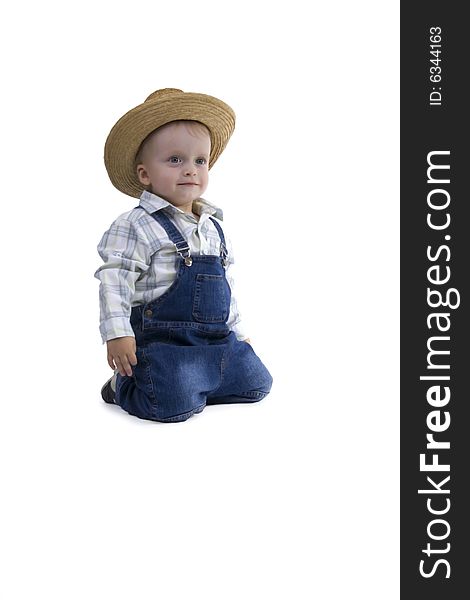 Sitting boy with straw hat on egg white background