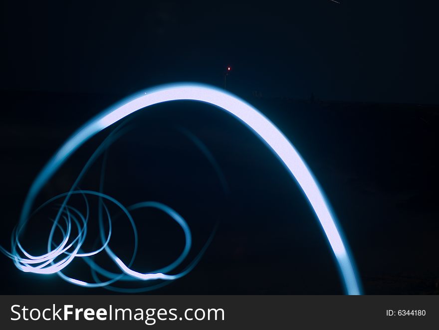 Swirling flashlight long exposure on beach. Swirling flashlight long exposure on beach