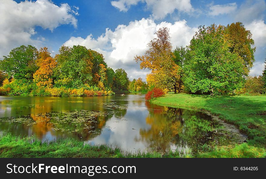 Bright autumn trees and boats in the park. Bright autumn trees and boats in the park