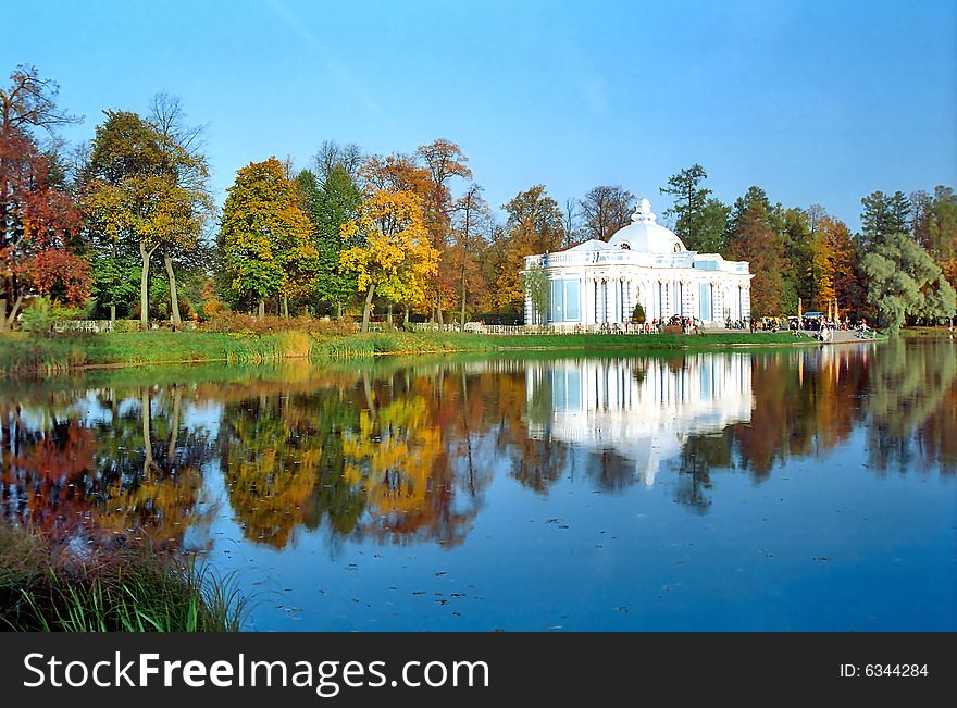 Classical building near the pond in autumn day