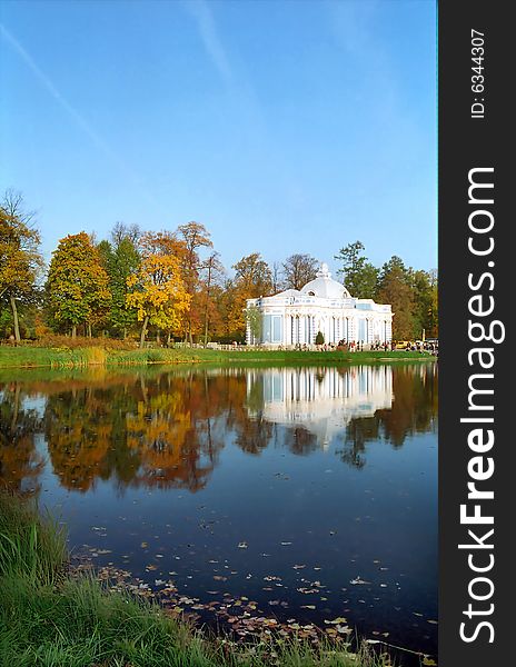 Classical building near the pond in autumn day vertical. Classical building near the pond in autumn day vertical