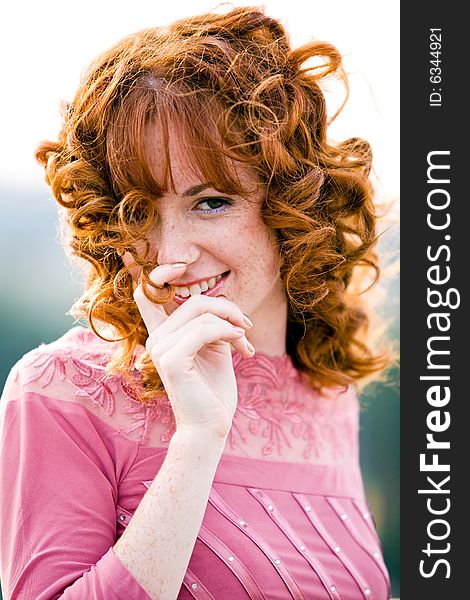 Close-up bright portrait of red-haired lovely young woman outdoors. Close-up bright portrait of red-haired lovely young woman outdoors