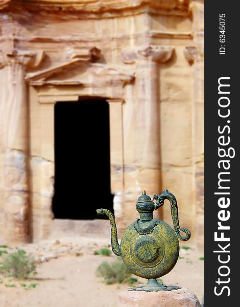 Ancient vessel on carved monastery background