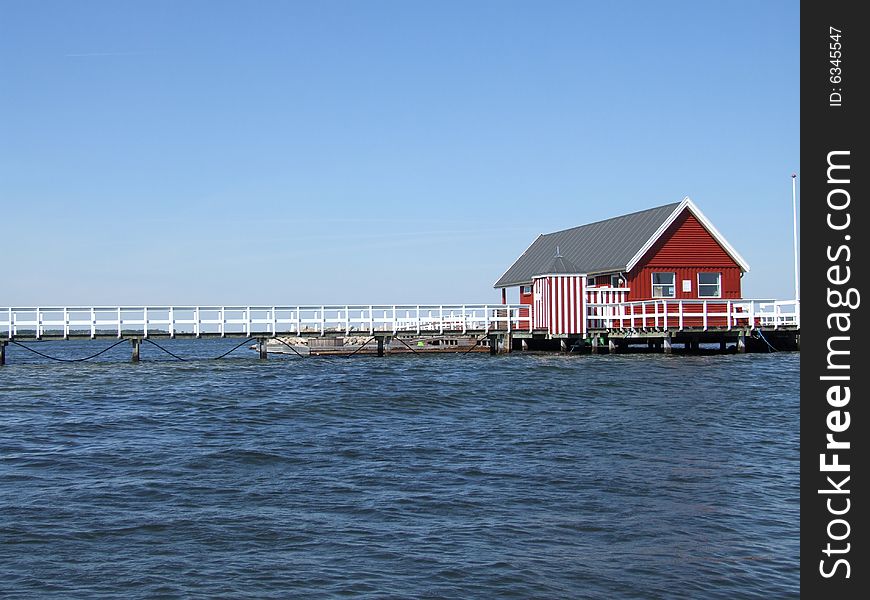Red log cabine at sea side
