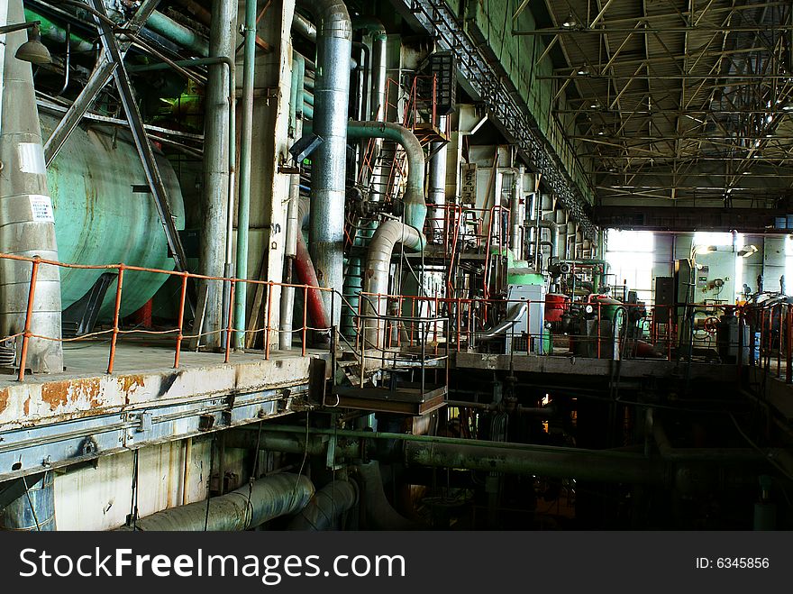 Equipment, cables and piping as found inside of a old industrial power plant. Equipment, cables and piping as found inside of a old industrial power plant