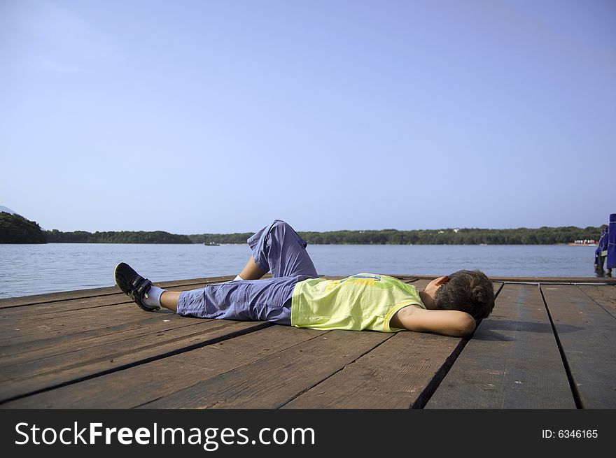 Emanuele takes a rest on the mole of the Lake of Paola (Sabaudia-Italy). Emanuele takes a rest on the mole of the Lake of Paola (Sabaudia-Italy)