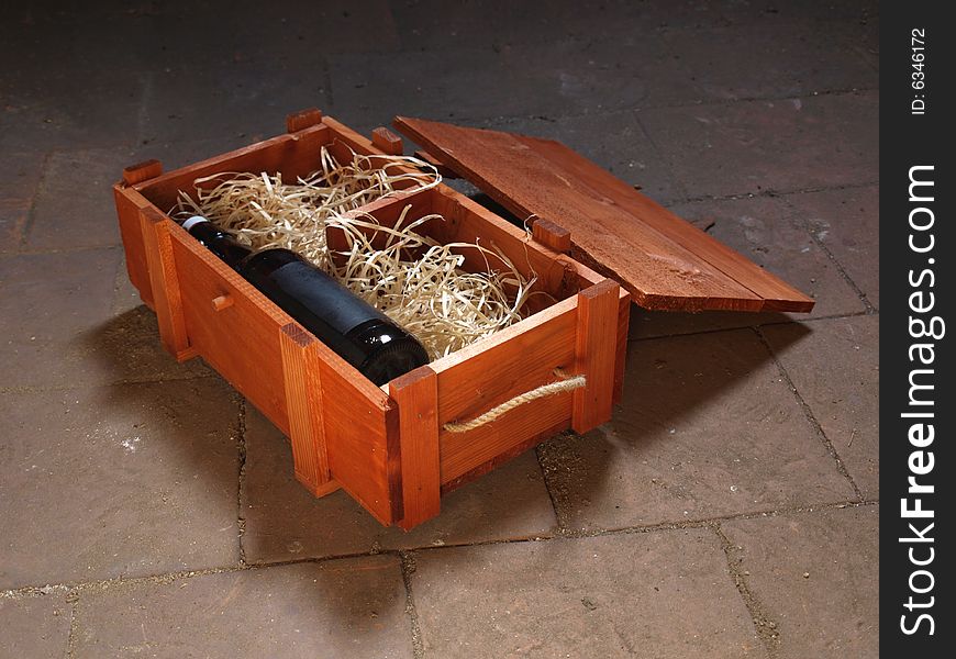 Old bottle of wine stored in wooden box. Old bottle of wine stored in wooden box