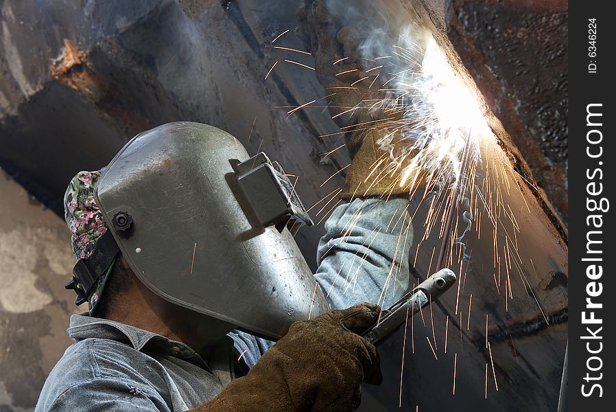 A metal welder busy at work
