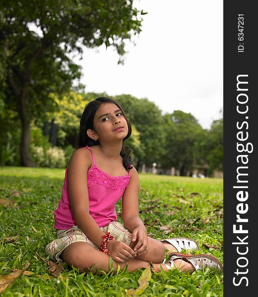 Asian girl sitting under a tree