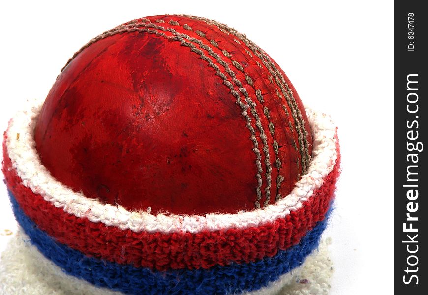 Red cricket ball with sweat band around it. Red cricket ball with sweat band around it