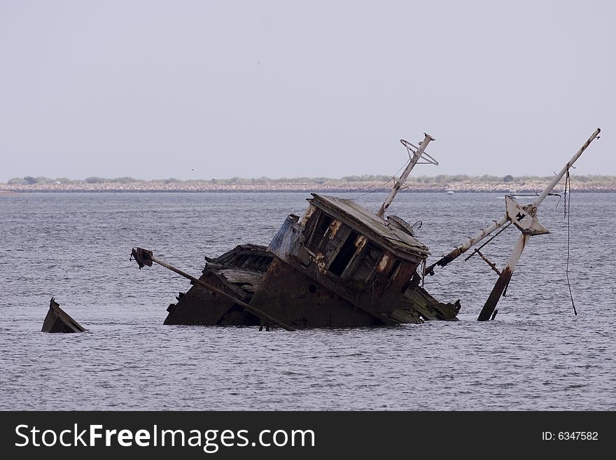 A stranded ship in the bay of ayamonte which is at the direct border between Spain and Portugal in Andalusia. A stranded ship in the bay of ayamonte which is at the direct border between Spain and Portugal in Andalusia.