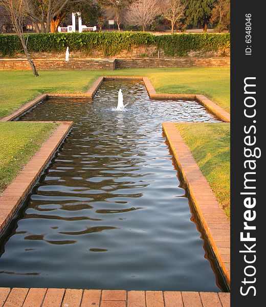 Fountain bubbling in a garden park. Fountain bubbling in a garden park