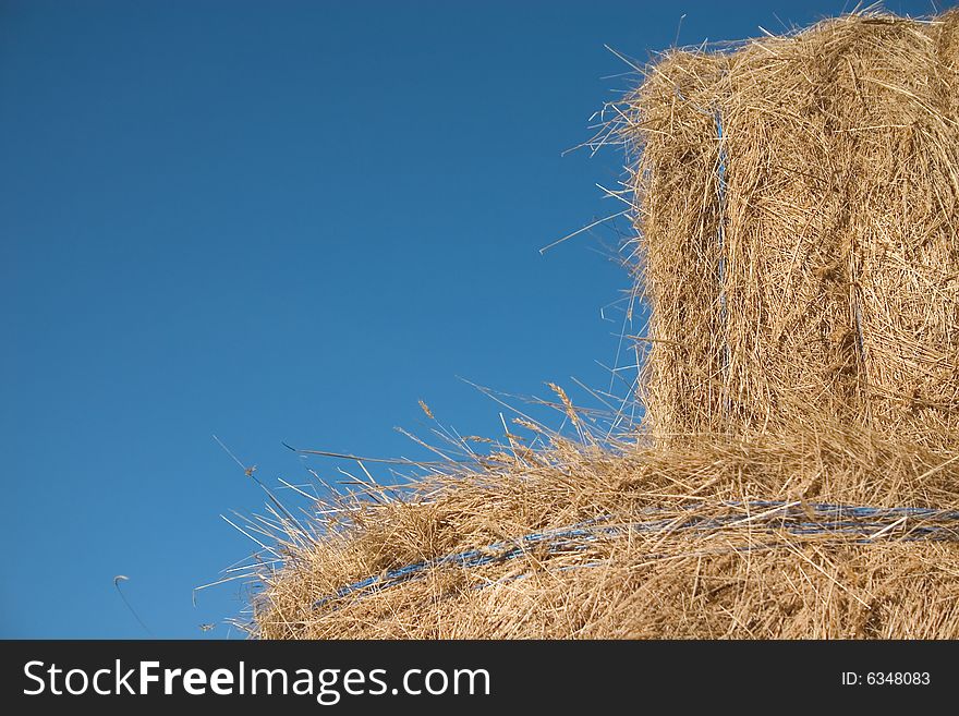 Two bales of hay in a blue sky
