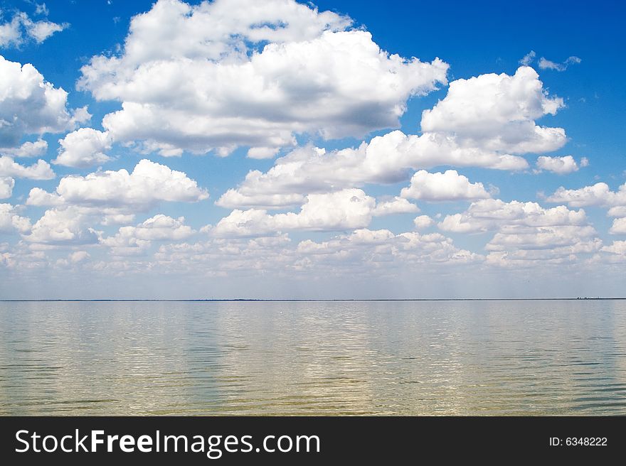 The blue sky and clouds over a sea bay