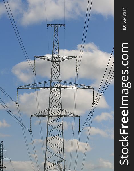 Electricity pylon with blue sky background.