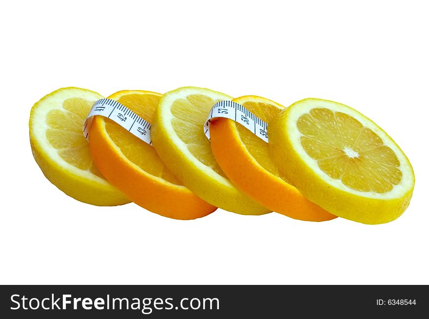 Cut by mugs lemon and an orange with a measuring tape.  diet.  healthy food and weight reduction. Cut by mugs lemon and an orange with a measuring tape.  diet.  healthy food and weight reduction