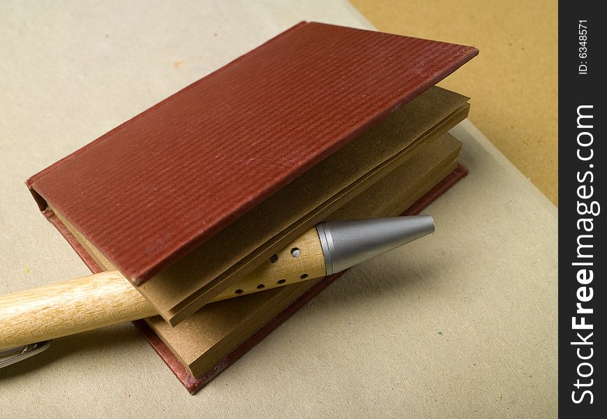 Pencil with small personal telephone register on a natural cardboard