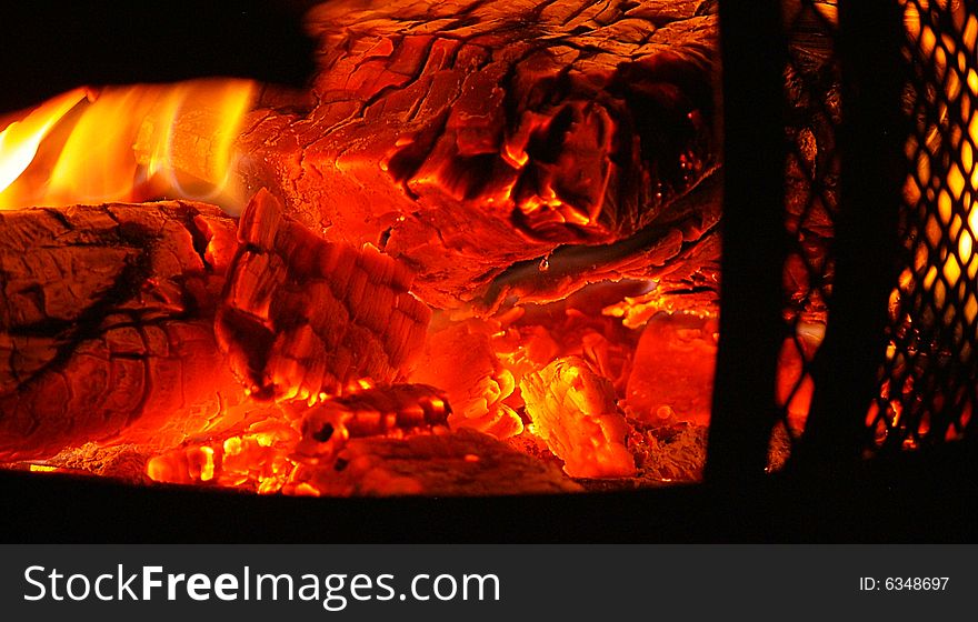 Sparks and fire inside of a chiminea. Sparks and fire inside of a chiminea