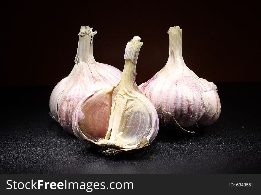 Photo product vegetables garlic on a dark background. Photo product vegetables garlic on a dark background