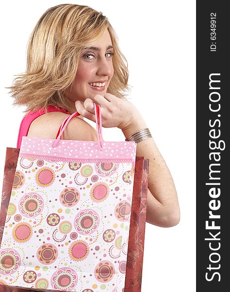 Portrait of a beautiful young blonde woman wearing a pink fashionable top and holding shopping bags over her shoulder. Isolated on white background. Portrait of a beautiful young blonde woman wearing a pink fashionable top and holding shopping bags over her shoulder. Isolated on white background