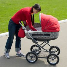 Woman With Baby Carriage Stock Photography