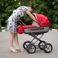 Woman With Baby Carriage Stock Images