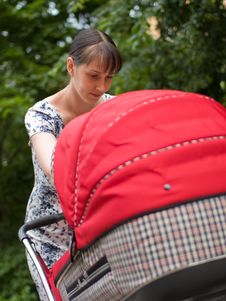Woman With Baby Carriage Royalty Free Stock Photography