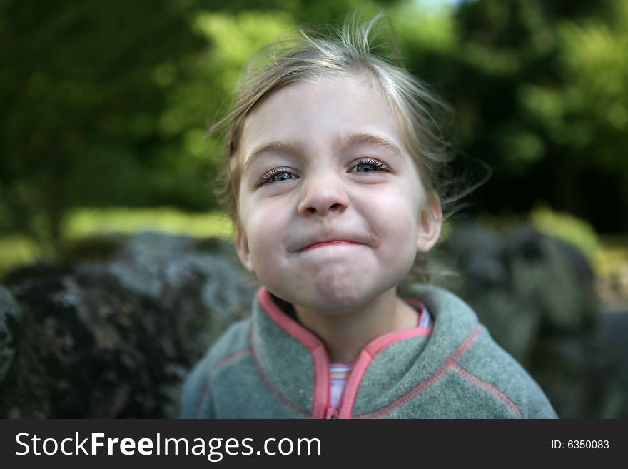 A little girl with a sceptic confident smile