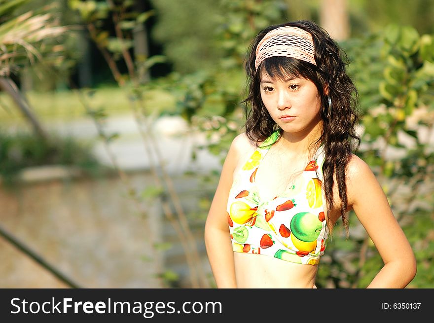 The bikini girl in a park . The bikini girl in a park .