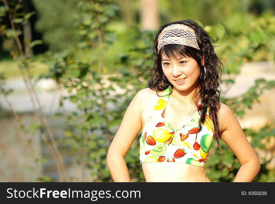 The bikini girl in a park . The bikini girl in a park .