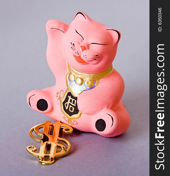 Maneki neko cat with golden dollar sign. Maneki neko cat with golden dollar sign