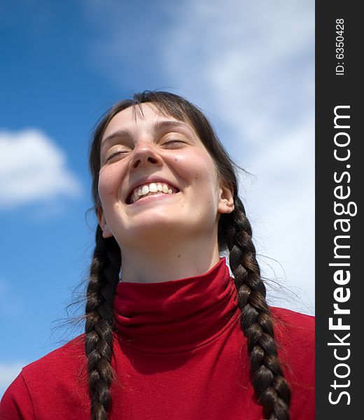 Smiling girl on the sky background
