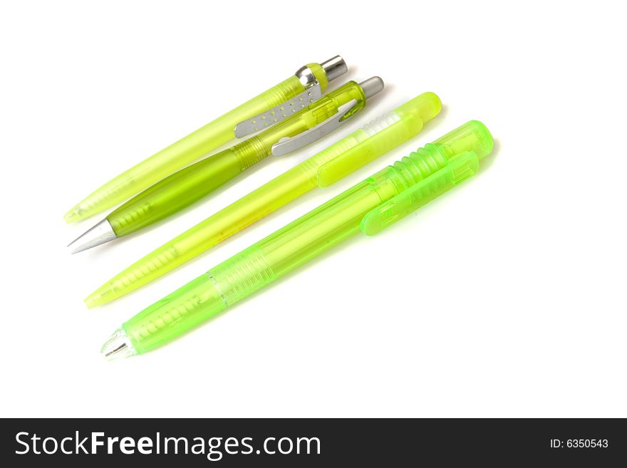 Four green plastic pens