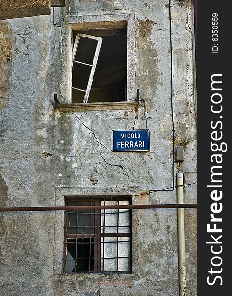 Dilapidated italian house windows with rotting walls and broken windowpanes. Dilapidated italian house windows with rotting walls and broken windowpanes