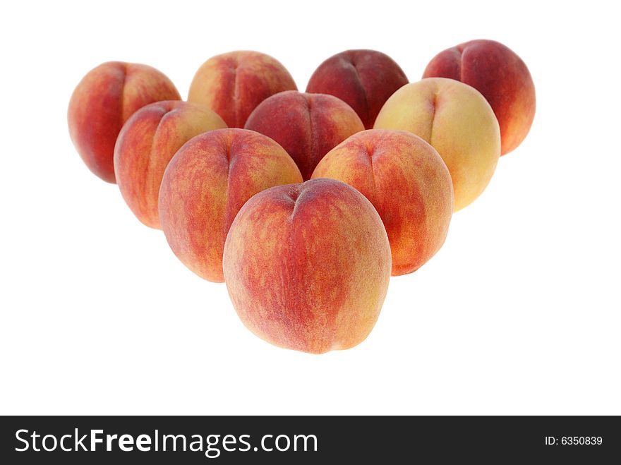 Big peaches arranged in triangle isolated on white background