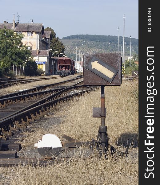 Standing goods train on train railway station with tracks