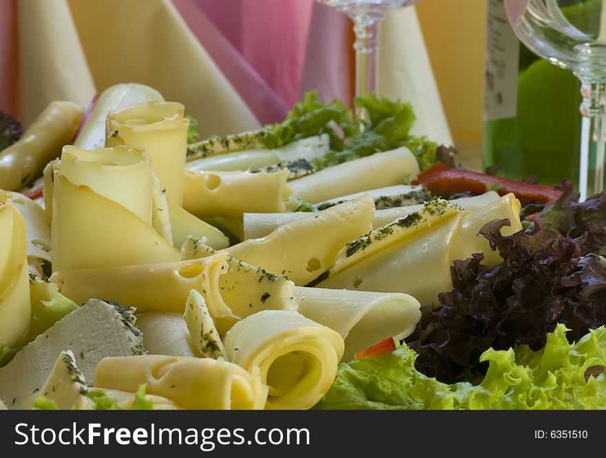 A cheese served with salad and ham. A cheese served with salad and ham