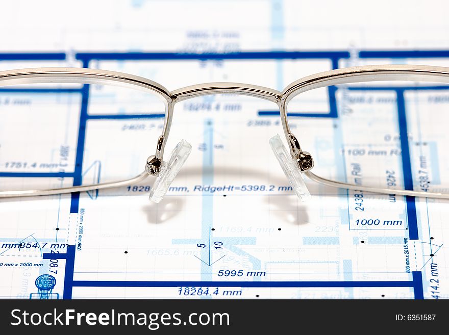 Blueprint for a house and eyeglasses