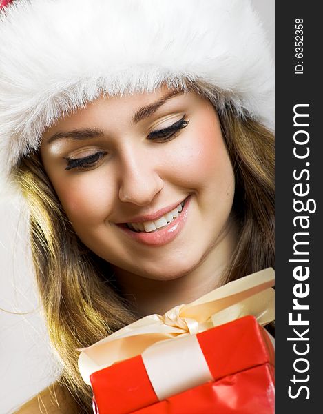 Winter portrait of a beautiful young smiling woman with a christmas cap. Winter portrait of a beautiful young smiling woman with a christmas cap