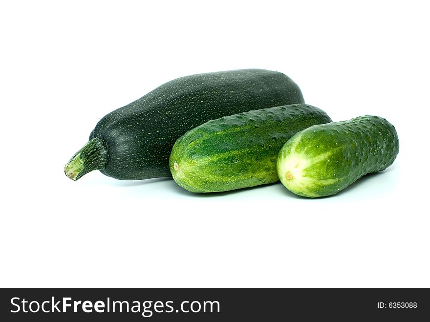 Cukini and pair of cucumbers isolated on the white background