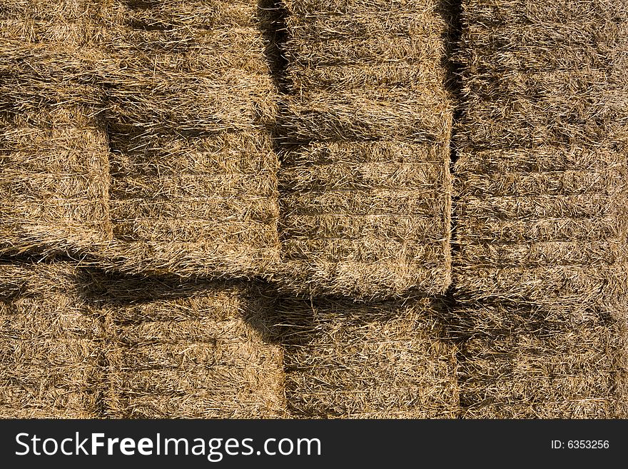 Straw bales stocked on storage place.