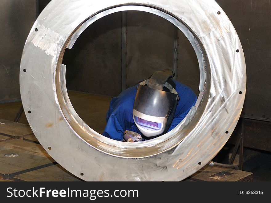 A metal welder busy at work. A metal welder busy at work